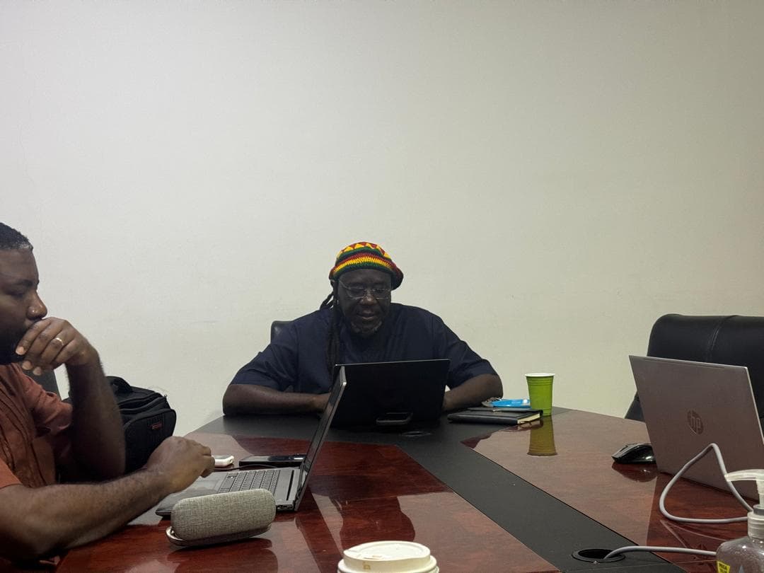 Colleagues working on laptops around a boardroom table